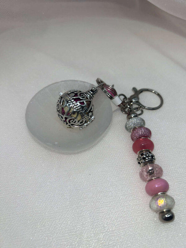 Keychain with Closed Orb with Crystals, Herbs, and Flowers Inside. Keychain with Closed Orb with Crystals, Herbs, and Flowers Inside.