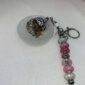 Keychain with Open Orb with Crystals, Herbs, and Flowers Inside.